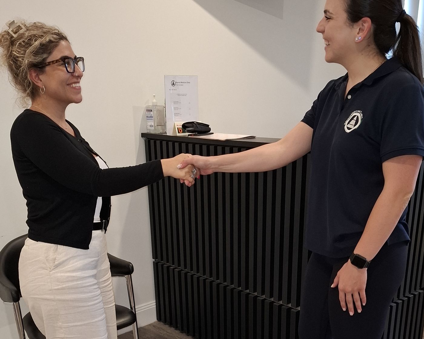 A patient being welcomed at reception at our Parramatta clinic